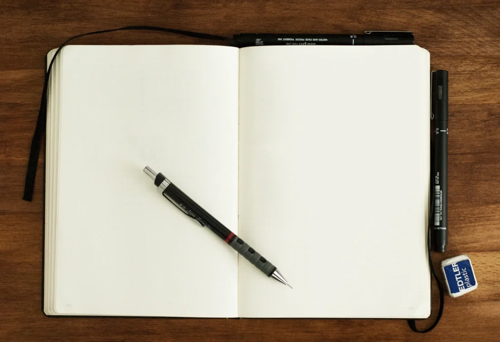 Orthodontic Marketing Budget Calculator 1 Notebook and pen used to plan an orthodontic marketing budget