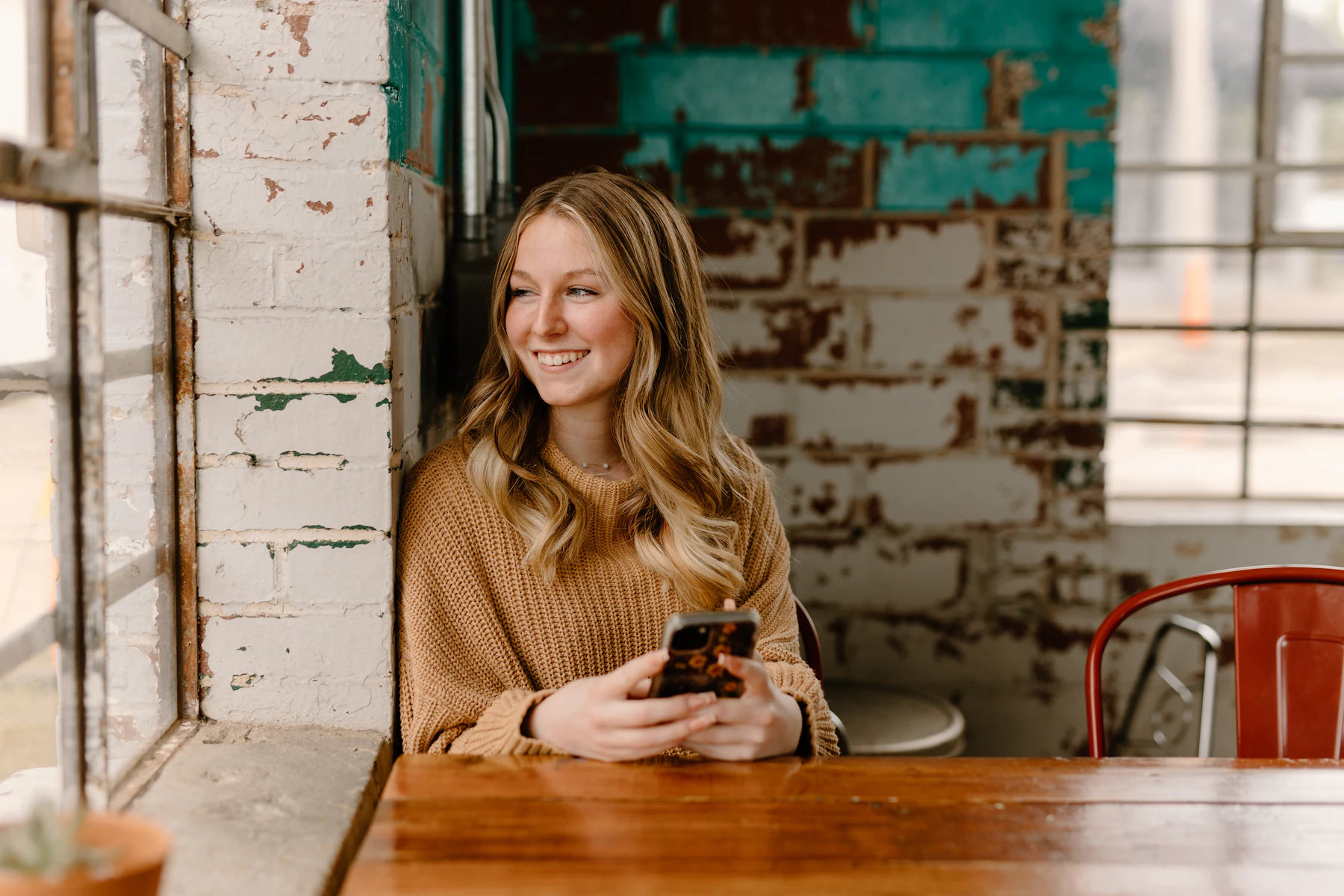 Home 3 Woman at a table looking at her phone
