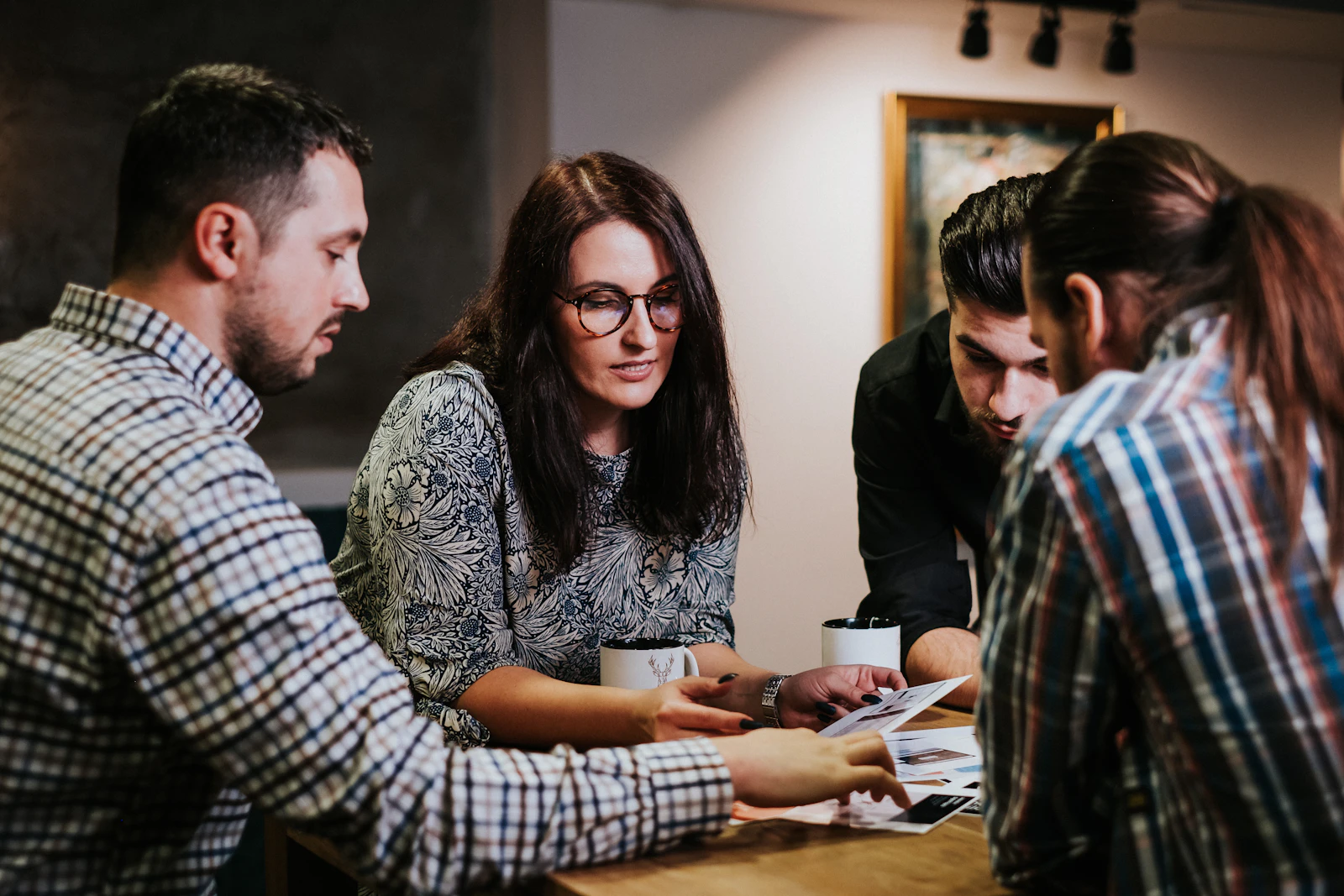 SEO Audit 1 People reviewing printed documents together at a wooden table